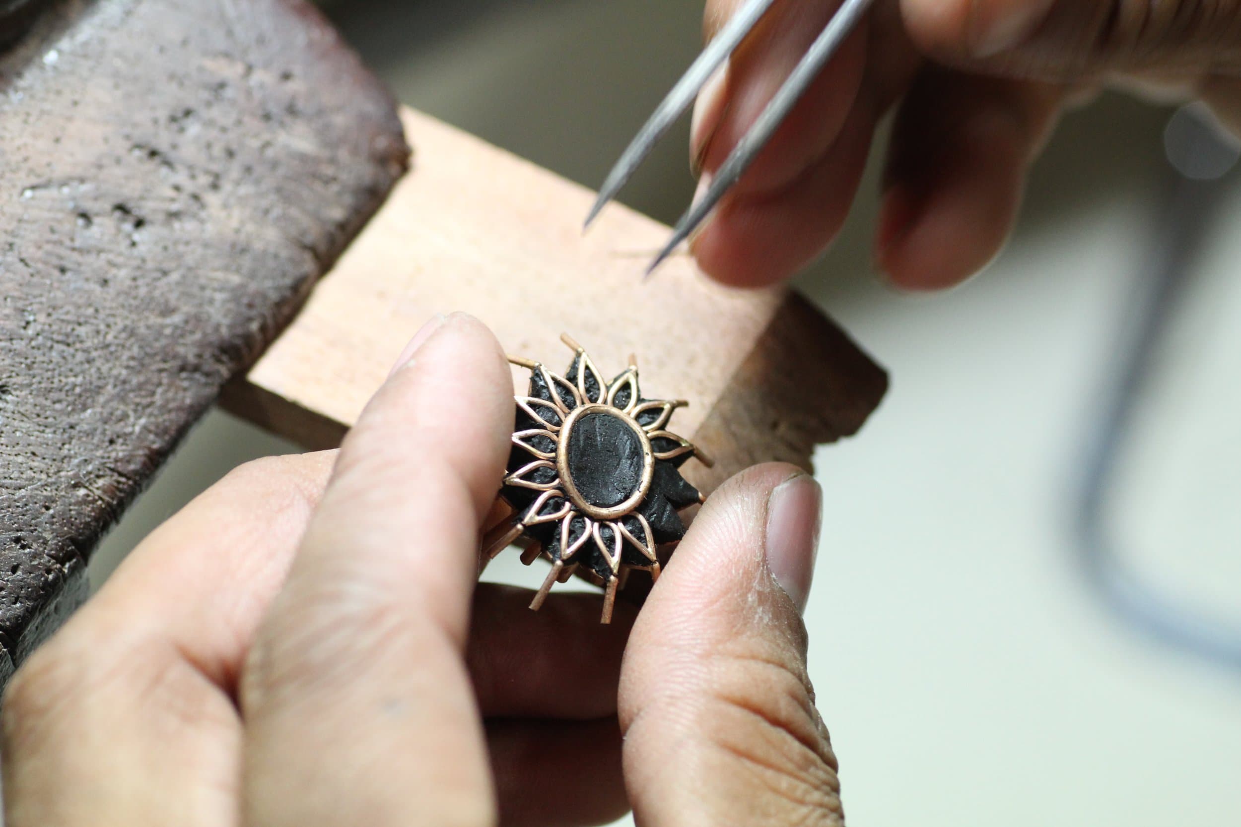 A craftsman handcrafting a commissioned piece at the Gem Plaza bench
